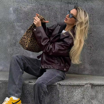 Solid color lapel jacket with zipper. Fashionable casual leather jacket with long sleeves. Women&
