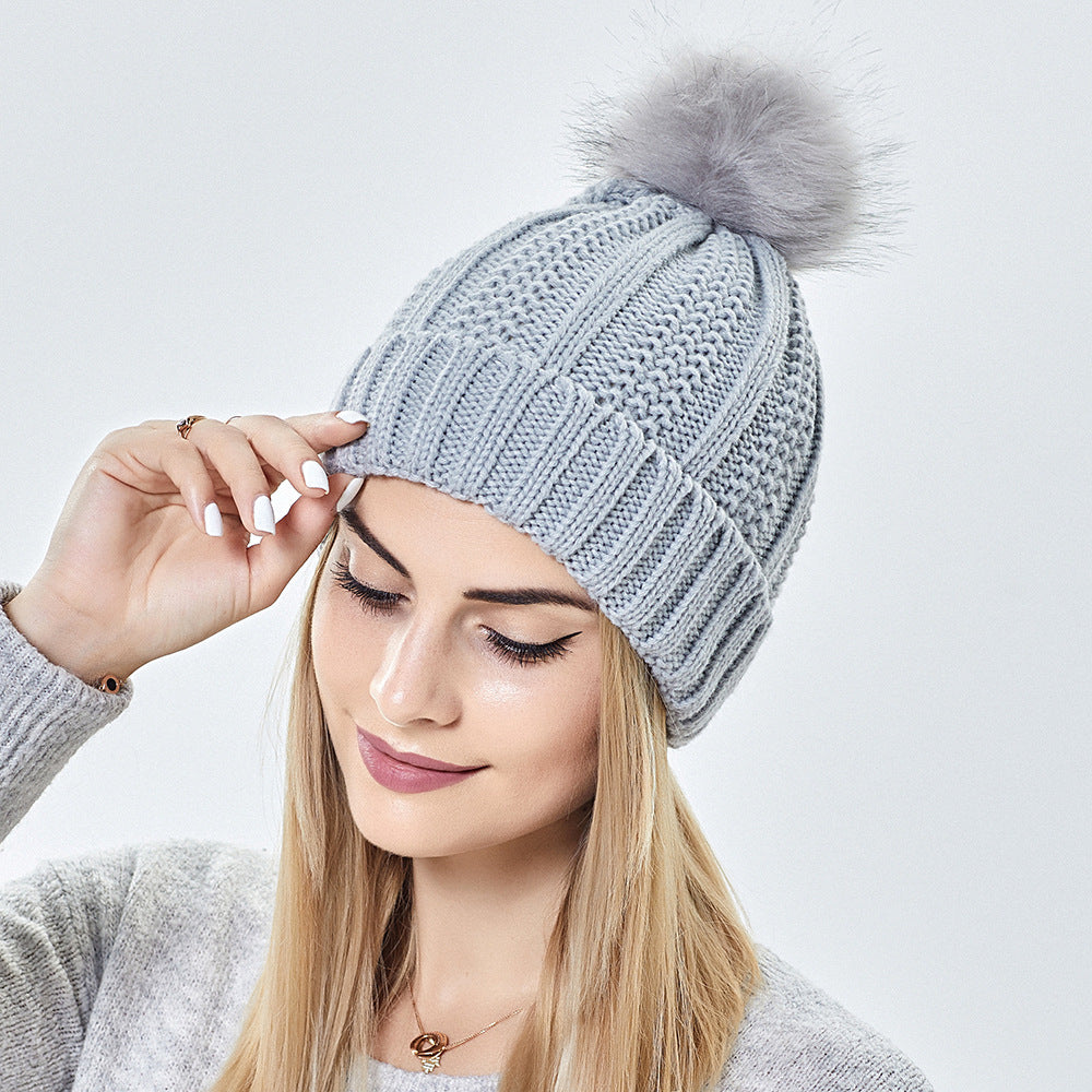 Fashionable stretchy knit hat with satin lining and skull design for women, faux fur pom-pom hat, winter hat to keep warm